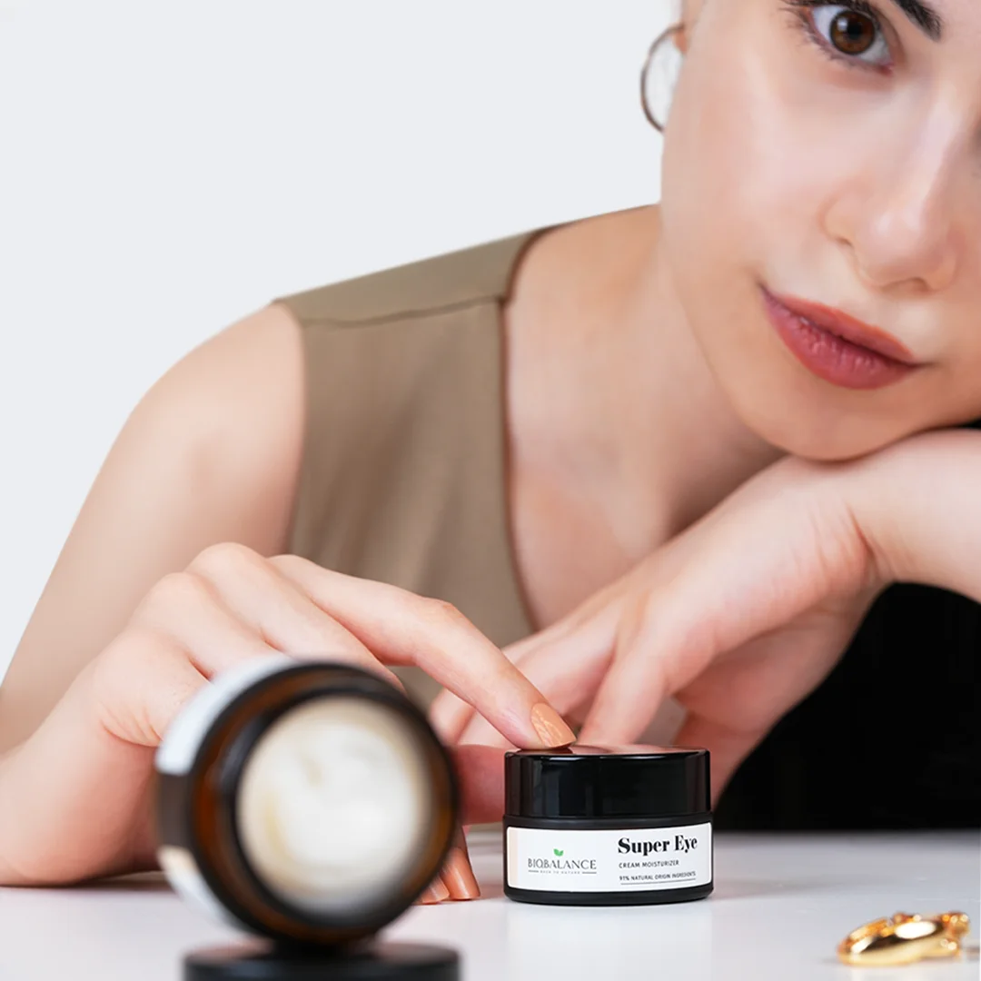 Woman applying BioBalance Super Eye Cream Moisturizer with her finger